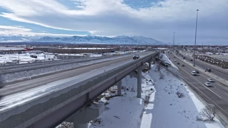 Winter-traffic-on-Spaghetti-Bowl-Interchange-overpass-in-Salt-Lake-City,-drone