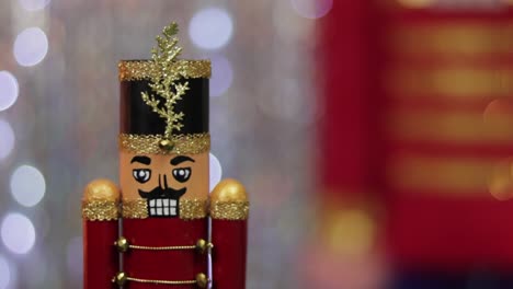 Christmas-toy-soldier-nutcracker,-same-large-figurine-behind,-bokeh