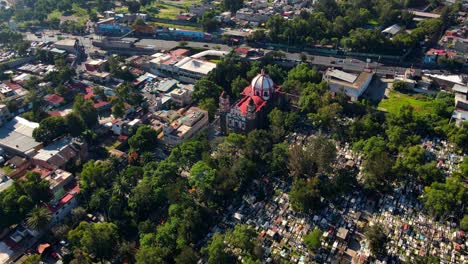 Flyover-establishing-in-descent-over-the-Cathedral-and-the-General-Pantheon-of-Iztapalapa-in-Mexico-City-on-a-sunny-day