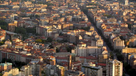 Milan-city-living-apartment-homes-lit-by-sunset-glow,-aerial-view