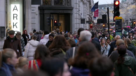 In-slow-motion-thousands-of-Christmas-shoppers-walk-along-Regent-Street-dressed-in-winter-clothing