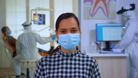 Portrait-of-woman-with-mask-in-dental-office-looking-on-camera