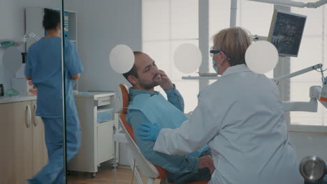 Patient-Mit-Zahnschmerzen-Erklärt-Dem-Zahnarzt-In-Der-Mundpflegeklinik-Seine-Schmerzen
