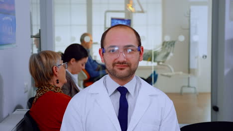 Portrait-of-stomatologist-smiling-at-camera-being-in-dental-office