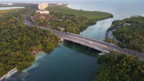 Aerial-view-of-Punta-Nizuc-bridge-with-cars-driving-towards-hotel-zone-of-Cancun,-Mexico