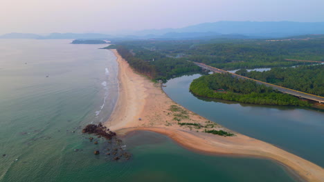 Tropical-Galgibaga-beach-with-ocean-and-trees-Goa-India-4K-Drone