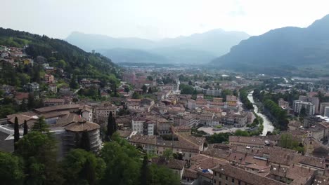 Beautiful-Italian-city-of-Rovereto-in-mountain-valley,-aerial-drone-view