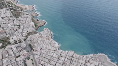 Aerial-footage-above-the-town-of-Polignano-a-Mare-on-a-cloudy-day-with-a-view-of-the-Mediterranean-Sea