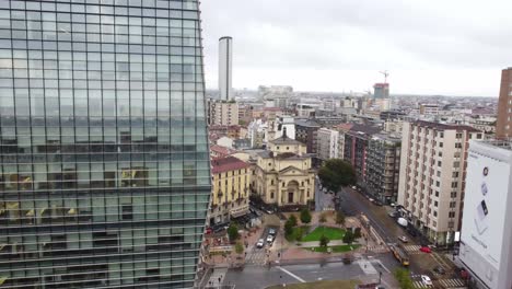 Modern-Diamond-tower-of-Milan-with-old-historical-buildings-in-background,-aerial-view