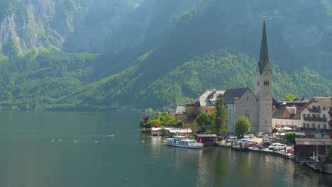 Majestic-and-Picturesque-Place-of-Hallstatt-with-People-Swimming-in-Lake