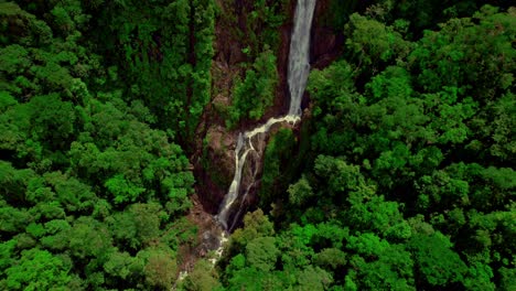 Breathtaking-top-down-drone-view-unveils-the-natural-splendor-of-Bijagual-Falls-in-Costa-Rica,-a-hidden-gem-in-the-rainforest