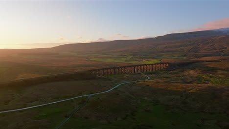 High-Establishing-Aerial-Drone-Shot-of-Ribblehead-Viaduct-at-Golden-Hour-Sunset-in-Yorkshire-Dales-UK