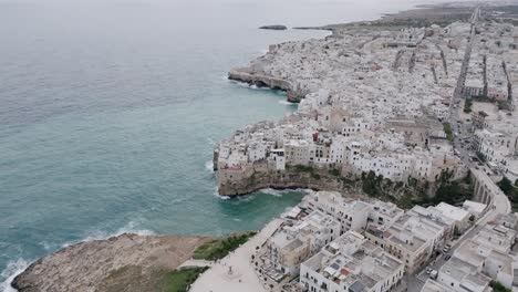 Rotating-aerial-footage-of-the-town-of-Polignano-a-Mare-during-a-stormy-day-in-Italy