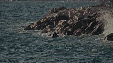 Waves-crashing-on-rocky-shore-in-slow-motion,-Naples,-Italy