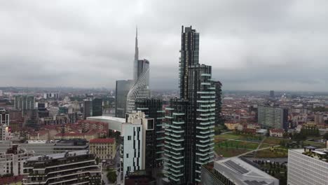Modern-downtown-and-skyscrapers-of-Milan-city,-aerial-orbit-view