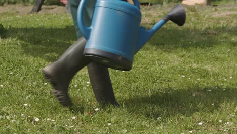 Man-Took-The-Plastic-Watering-Can-On-The-Lawn