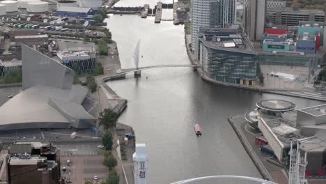 Millennium-Bridge-and-Media-City-Footbridge-over-Manchester-Ship-Canal,-aerial
