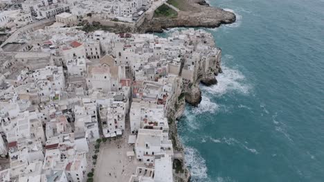 Aerial-footage-panning-up-to-show-the-town-of-Polignano-a-Mare-and-the-Mediterranean-Sea