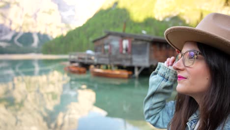 Beautiful-white-woman-with-hat-admiring-Lago-di-Braies-in-daytime