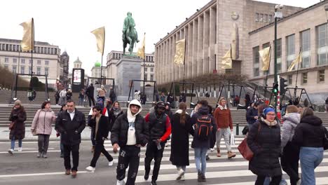 A-diverse-group-of-people-using-the-city-crosswalk-at-Mont-Des-Arts-in-Brussels,-Belgium