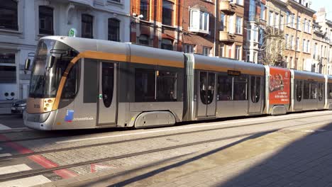 Modern-tram-on-its-way-in-central-street-of-municipality-Etterbeek-in-Brussels,-Belgium