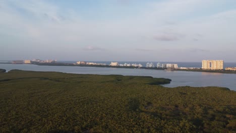 Panoramic-aerial-view-of-Nichupte-Lagoon-over-Punta-Nizuc-bridge-with-Cancun-hotel-zone-in-background