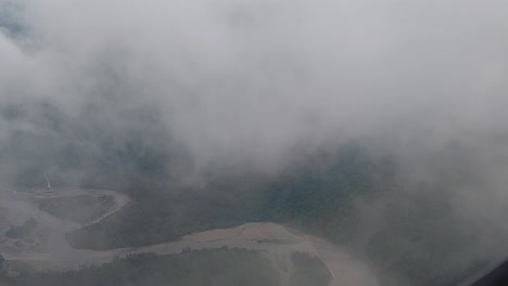 fly-over-the-beautiful-Timika-sky-through-the-clouds-and-witness-the-beauty-of-the-river-in-the-city-of-Timika,-West-Papua-province