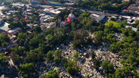 Dolly-out-bird's-eye-view-of-the-Cathedral-and-the-General-Pantheon-of-Iztapalapa-on-a-sunny-day,-CDMX