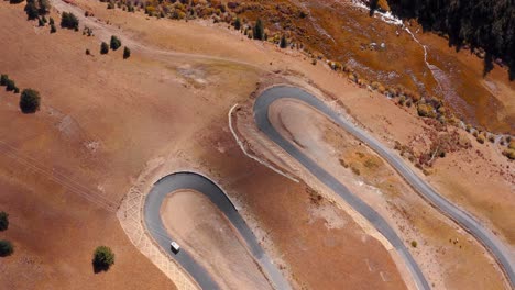 Overhead-View-Of-A-Car-Driving-Through-Hairpin-Turn-Road