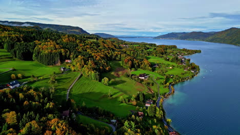A-countryside-village-along-Attersee-Lake,-Austria-in-autumn---aerial-flyover