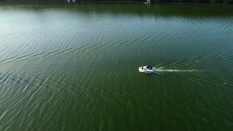 Two-sport-boats-driving-on-a-small-lake-in-Brandenburg,-Germany