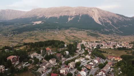 Campo-di-Giove-township-surrounded-with-mountains-in-Italy,-aerial-view