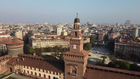 Milan-castle-tower-on-cityscape-behind,-aerial-drone-view
