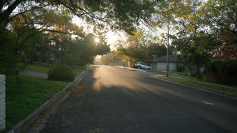 Wide-shot-of-empty-street-road-in-quiet-and-still-neighborhood-at-sunrise