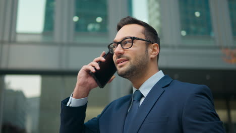 Joyful-French-man-talking-mobile-phone-on-office-terrace-outdoors-happy-smiling-businessman-employer-ceo-executive-talk-smartphone-in-city-friendly-business-conversation-cellphone-call---portrait