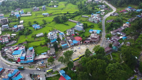 Aerial-View-Of-Houses-In-A-Small-Town-With-Green-Meadow-In-Nepal