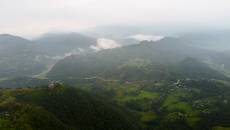 Panoramic-aerial-overview-of-ridgeline-overlooking-winding-road-between-valleys-in-Nepal