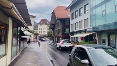 Interlaken-Switzerland-Immersive-Travel-Tourism-Mountainside-Valley-Resort-City,-Europe,-Walking,-Rainy-Day,-4K-|-Looking-Around,-Shaky,-Water,-River,-Lake,-Restaurant,-Alley,-Bank,-Cafe
