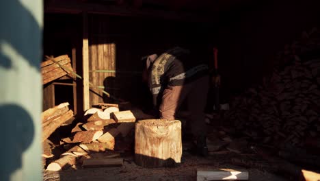 Man-Chopping-Woods-Using-Axe-With-Sunlight