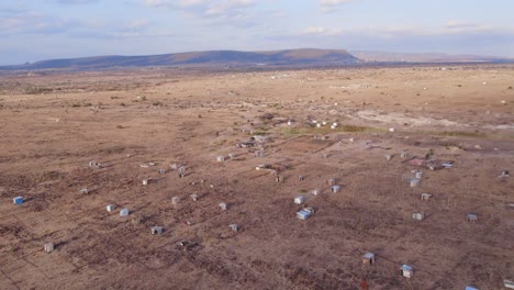 Aerial-view-over-a-dried-out-landscape-with-small-garden-houses-where-there-were-fields