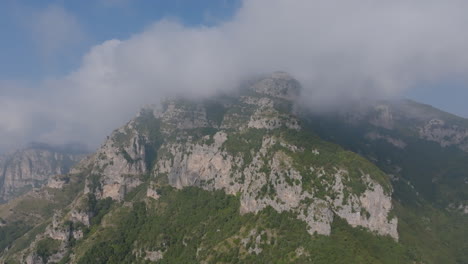 Aerial-footage-flying-towards-the-cloud-covered-tops-of-the-mountains-on-the-Amalfi-Coast,-Italy