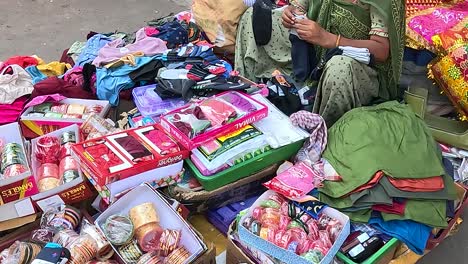 A-lady-shopkeeper-is-selling-useful-items-to-ladies-on-street-Road