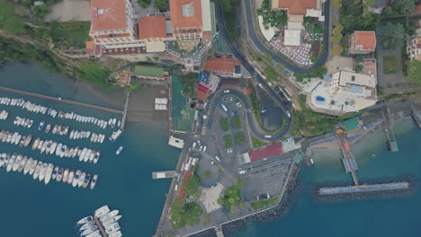 Slowly-rotating-top-down-aerial-of-the-ferry-docking-port-in-the-town-of-Sorrento,-Italy