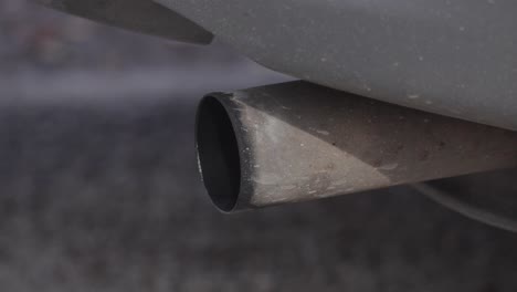 Harmful-polluting-exhaust-pipe-fumes-rising-from-stationary-vehicle-tailpipe