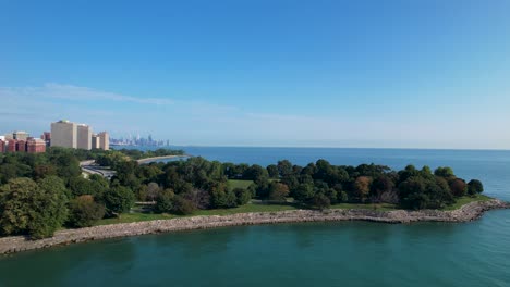 Lush-Green-Park-Tress-Next-To-Waterfront-With-Chicago-Skyline-Drone