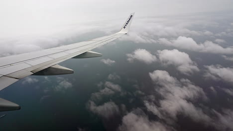 Wing-And-Winglet-Of-Ryanair-Airliner-In-Flight-Against-Sky-With-Clouds