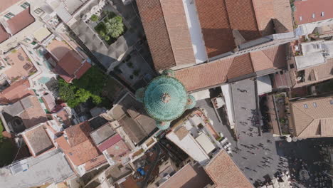 Top-down-aerial-footage-flying-up-away-from-the-spire-of-a-church,-the-Duomo-di-Amalfi-in-Amalfi