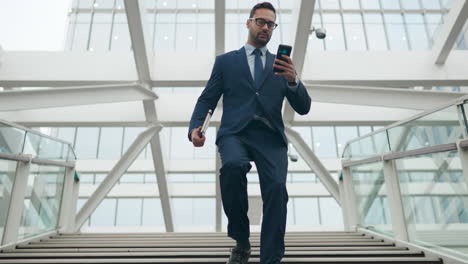 Businessman-Male-Professional-Running-Down-Stairs-While-Using-Phone-On-The-Move---Low-Angle