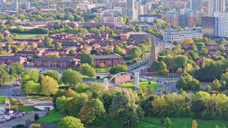 Zoomed-lifting-drone-shot-of-a-densely-populated-neighborhood-in-Manchester-on-a-sunny-day