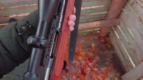 Close-up,-an-ammunition-clip-is-inserted-into-a-hunting-rifle,-then-the-rifle-is-loaded